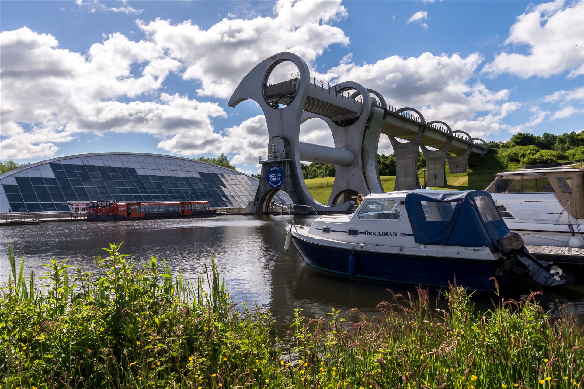 The Falkirk Wheel - The Falkirk Wheel is a rotating boat lift in Scotland, connecting the Forth and Clyde Canal with the Union Canal. It opened in 2002, reconnecting the two canals for the first time since the 1930s as part of the Millennium Link project. by philreay