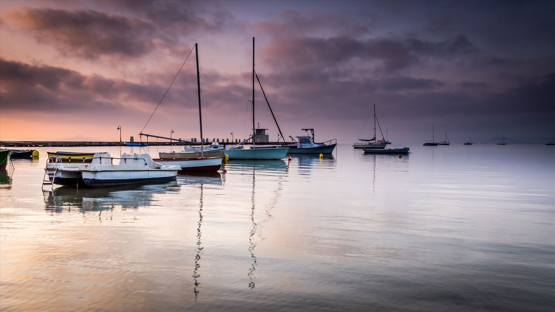 Sunrise over the Mar MenorThe Mar Menor (meaning Minor sea or Smaller Sea in Spanish)  is a coastal salty lagoon in the Iberian Peninsula of Spain with a surface area of nearly 170 km². With warm and clear water no more than 7 metres in depth, it is the largest lagoon in Spain.