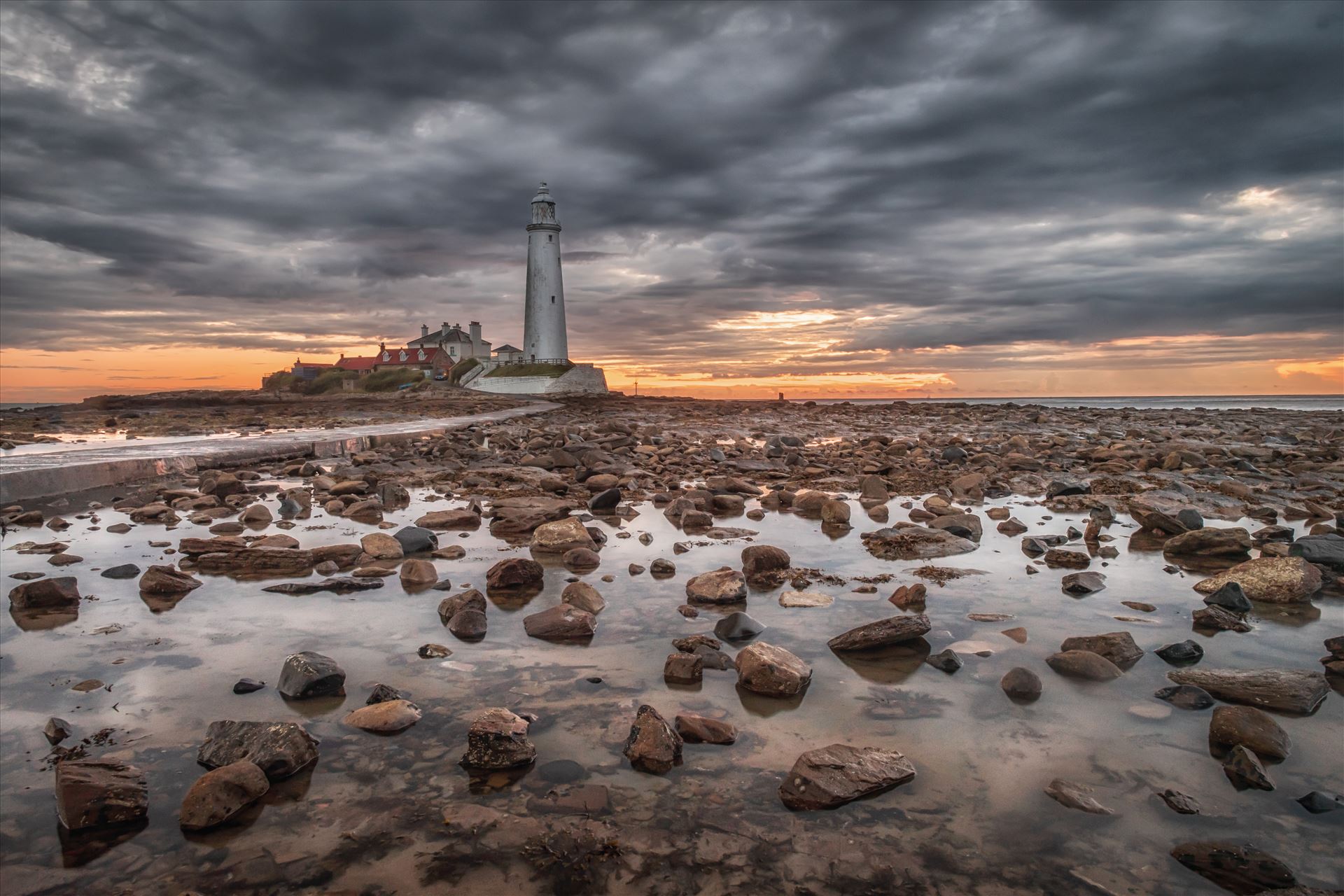 St Mary`s Lighthouse & island - St Mary`s lighthouse stands on a small rocky tidal island is linked to the mainland by a short concrete causeway which is submerged at high tide. The lighthouse was built in 1898 & was decommissioned in 1984, 2 years after becoming automatic. by philreay