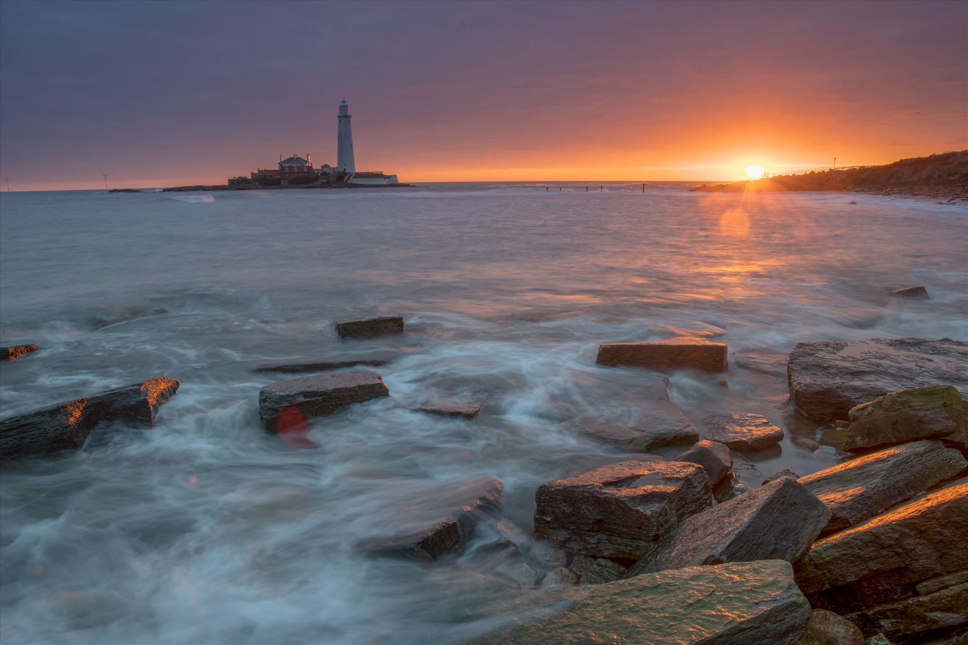 St Mary`s sunrise - St Mary`s lighthouse stands on a small rocky tidal island is linked to the mainland by a short concrete causeway which is submerged at high tide. The lighthouse was built in 1898 & was decommissioned in 1984, 2 years after becoming automatic. by philreay