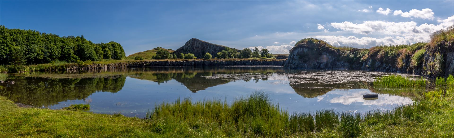 Cawfields Quarry - Cawfields is a former quarry cutting dramatically through the Wall and the underlying Whin Sill dolerite bedrock. It comprises a large pond and car park with good walking access to Milecastle 42 on the Roman Wall. by philreay