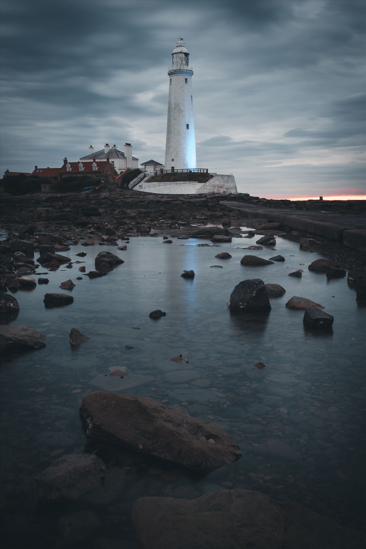 St Mary`s Island & lighthouse - St Mary`s lighthouse stands on a small rocky tidal island is linked to the mainland by a short concrete causeway which is submerged at high tide. The lighthouse was built in 1898 & was decommissioned in 1984, 2 years after becoming automatic. by philreay