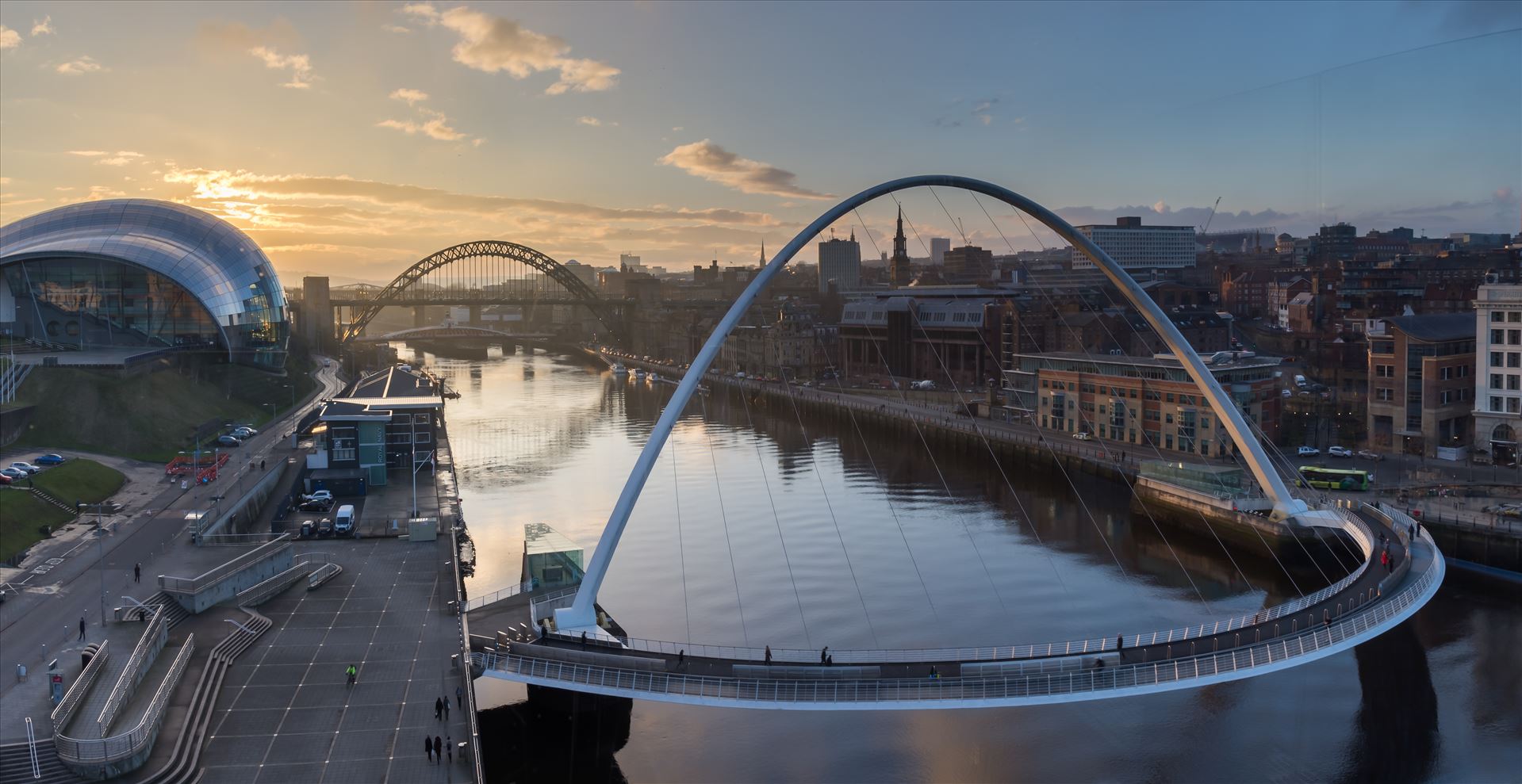 Gateshead & Newcastle quaysides at sunset - Taken from the viewing platform on level 4 of the Baltic arts building. This photo is made from 3 separate images stitched together to make this panoramic shot. by philreay